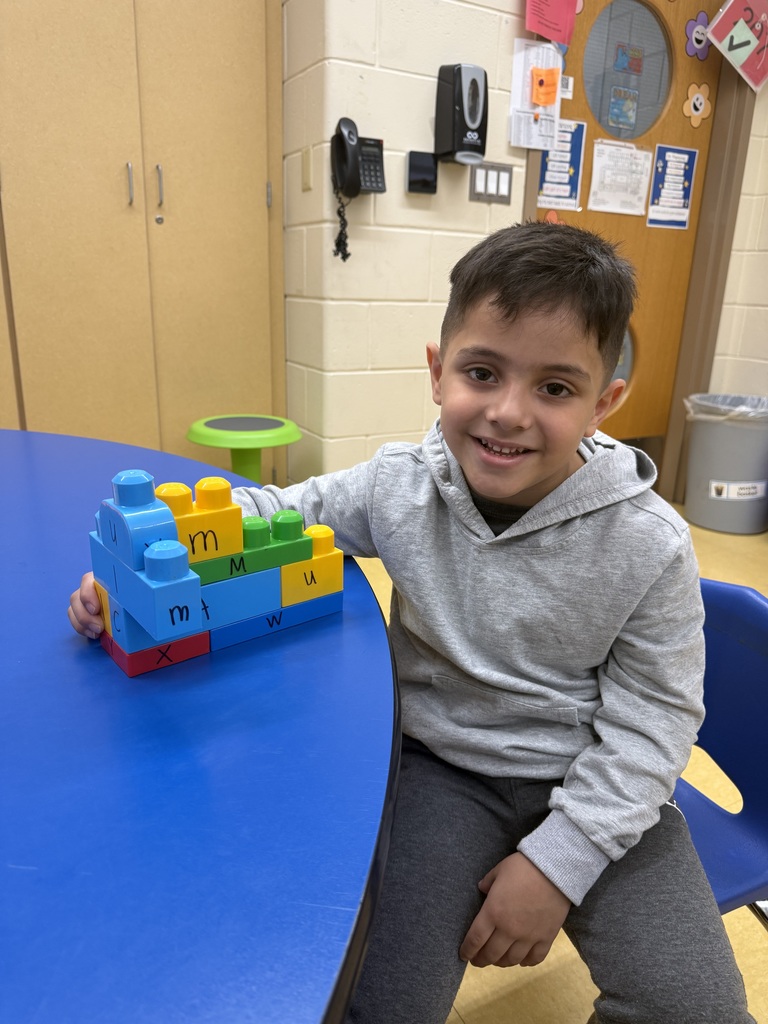 Lucas made a tower of letters at Parsons with Mrs. Fama.