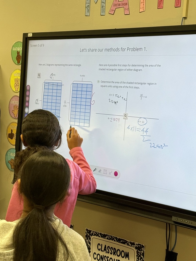 Students solving math problems on the board
