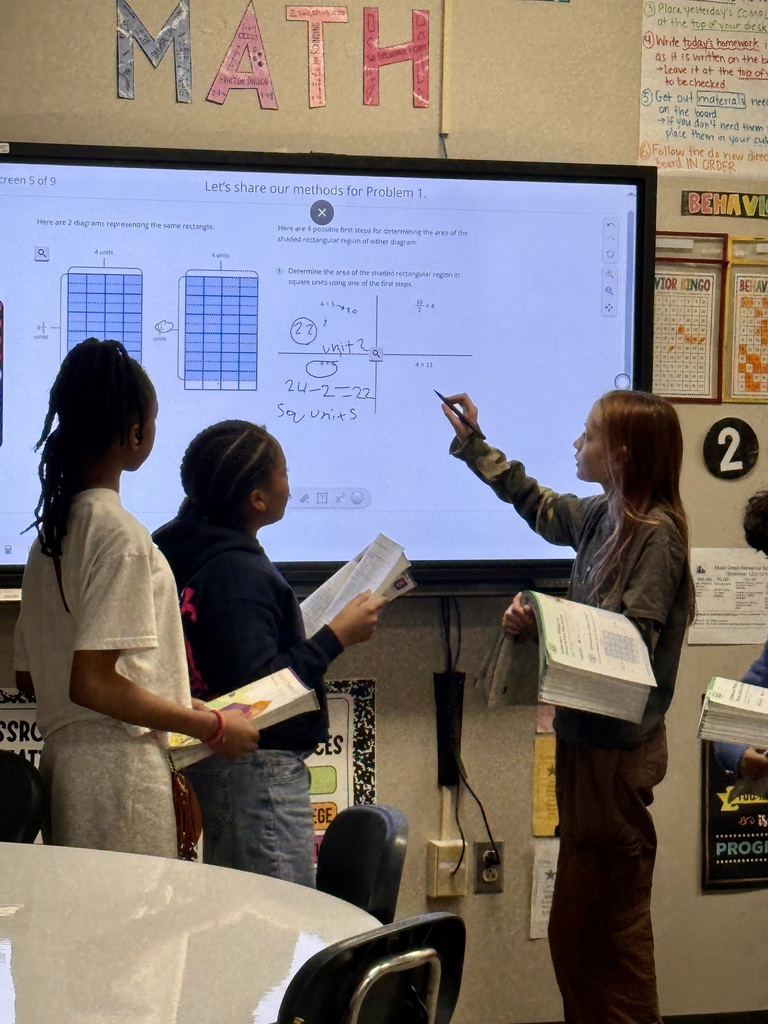 Students solving math problems on the board