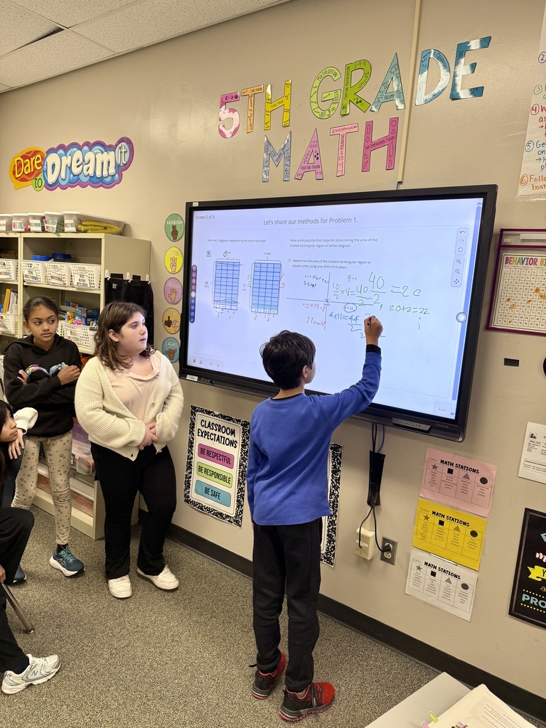 Students solving math problems on the board
