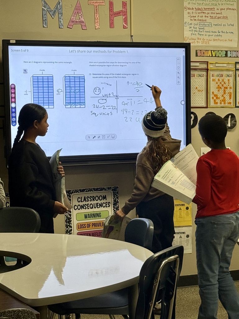 Students solving math problems on the board
