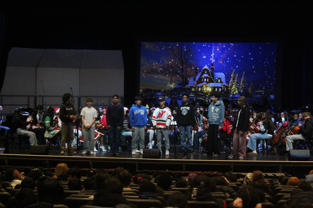 Student in festive holiday attire playing music