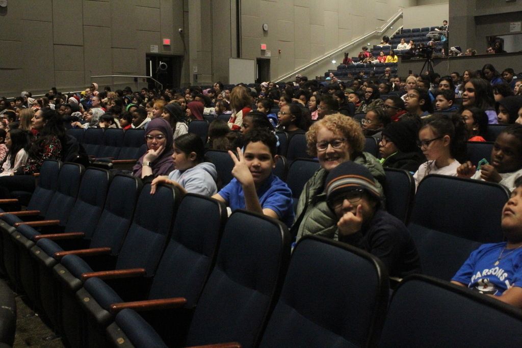 Students excitedly waiting for performance to begin 