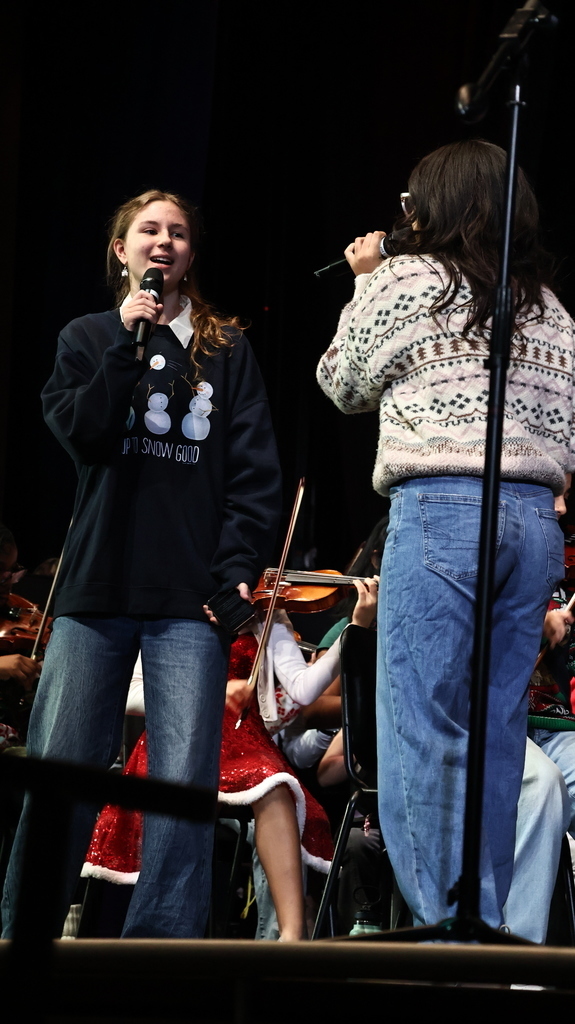 Student in festive holiday attire playing music