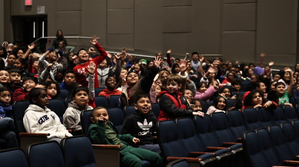 Students excitedly waiting for performance to begin 
