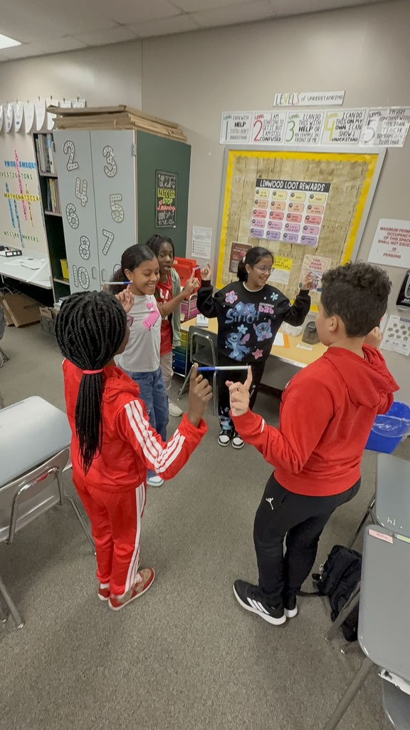 Students balancing pens in a team building activity