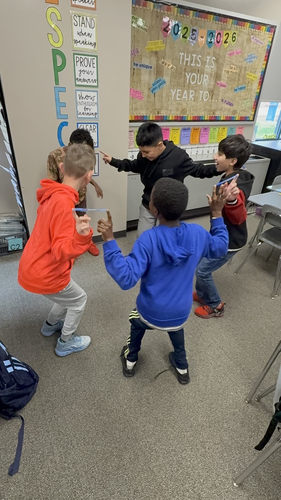 Students balancing pens in a team building activity