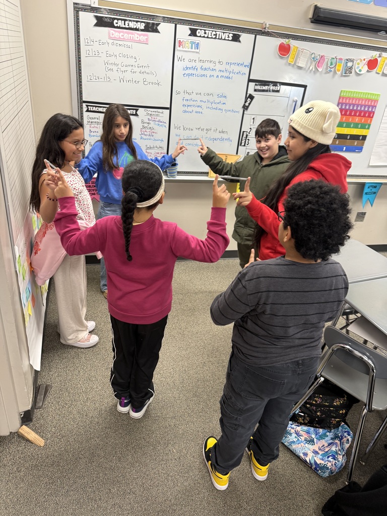 Students balancing pens in a team building activity