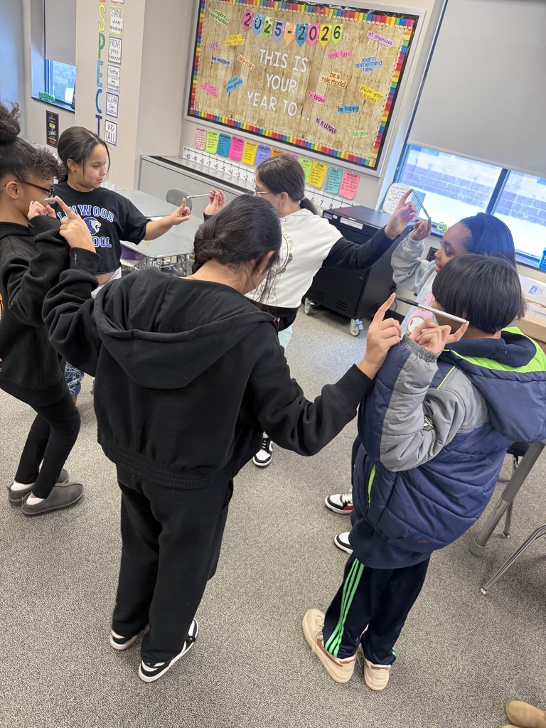 Students balancing pens in a team building activity