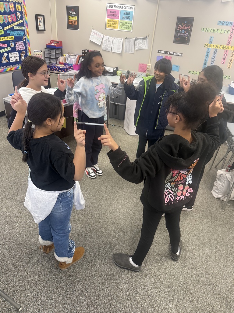 Students balancing pens in a team building activity