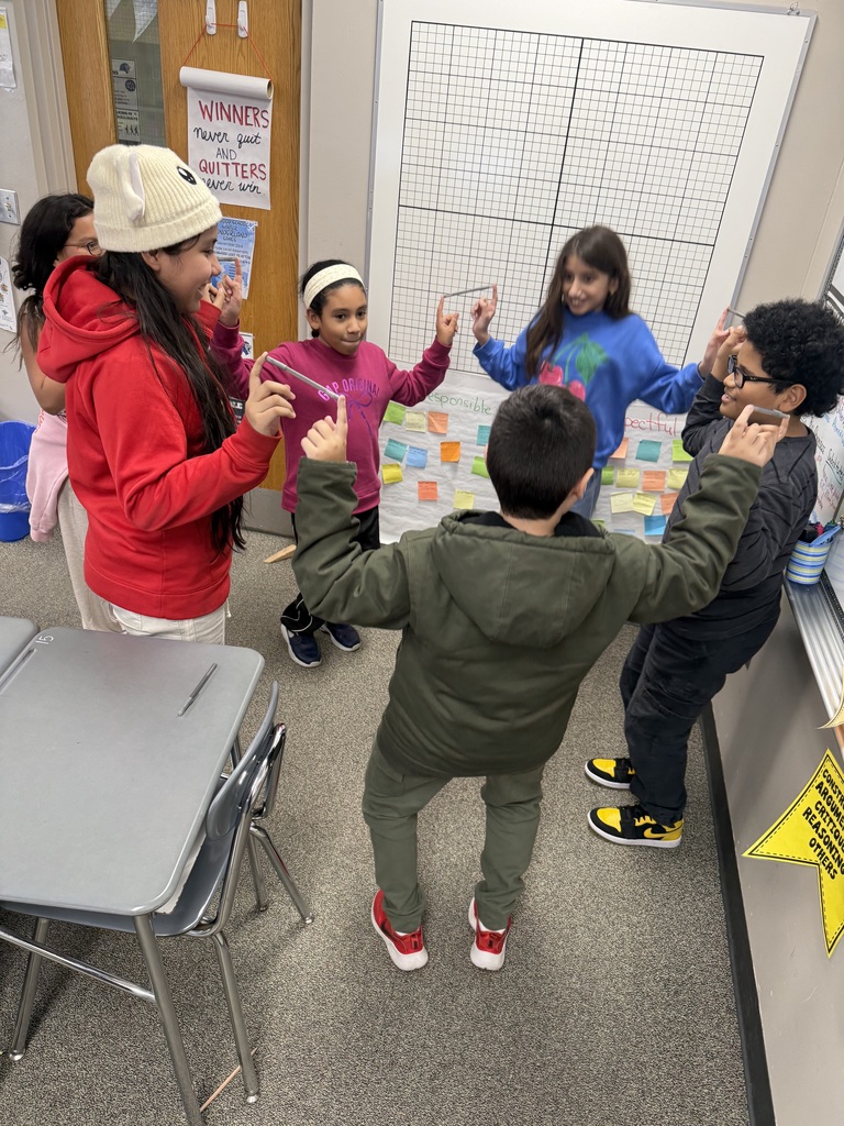 Students balancing pens in a team building activity