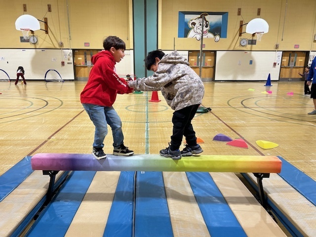 Students work together to balance across the icy arctic.