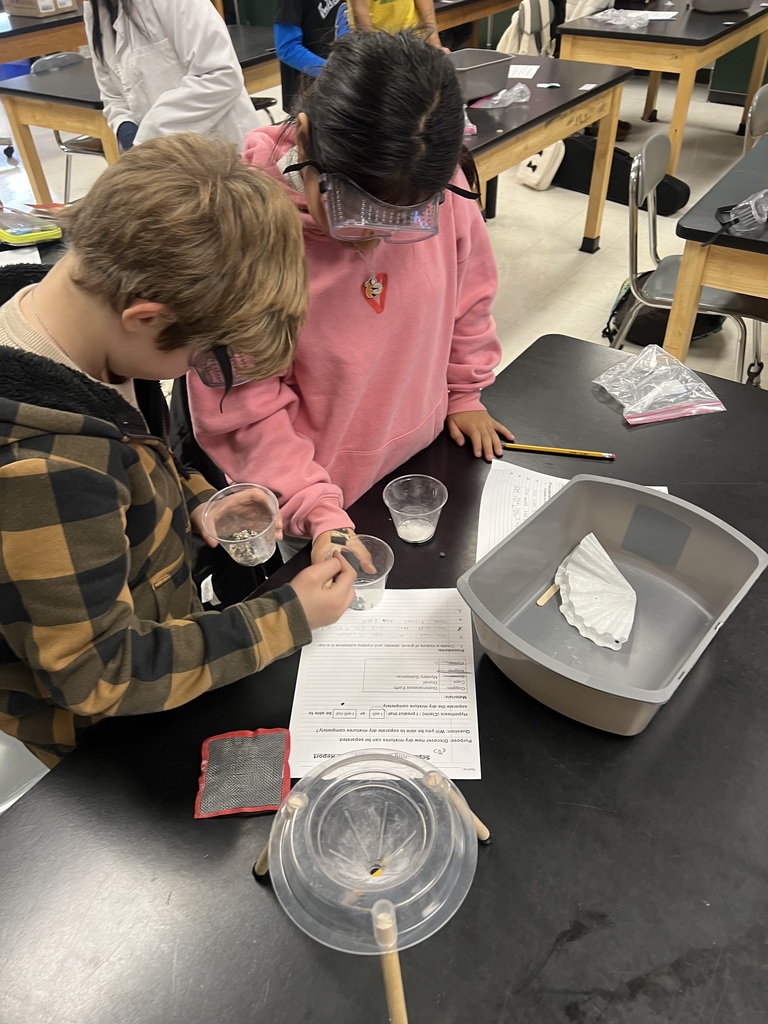 Using science tools to separate a mixture.