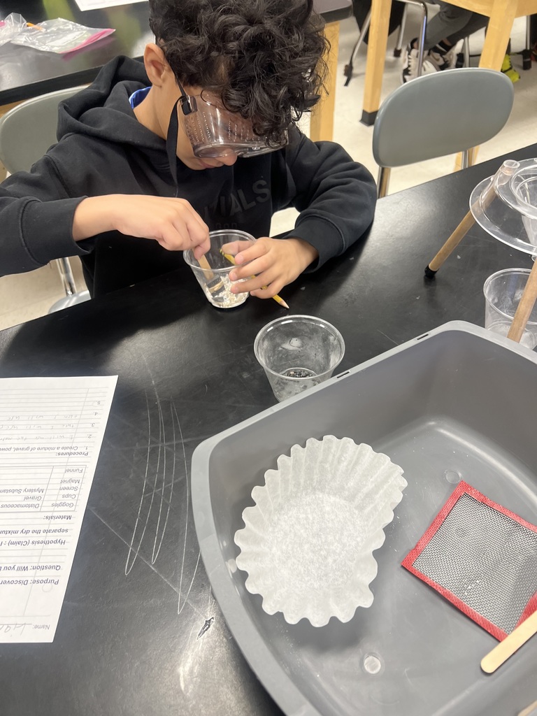 Using science tools to separate a mixture.