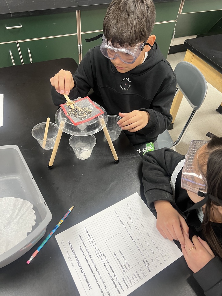 Using science tools to separate a mixture.