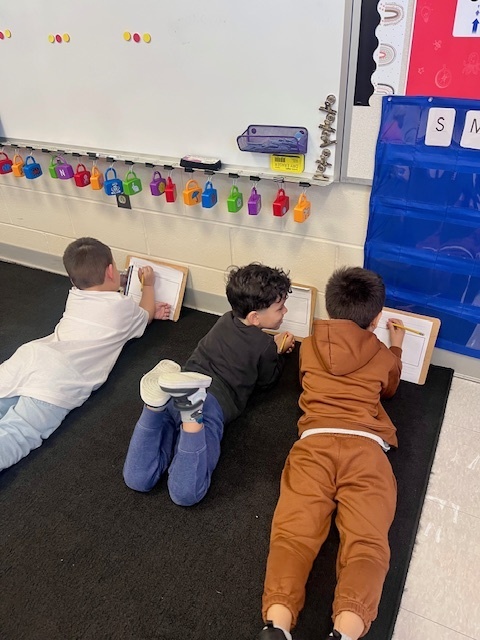 students writing on clipboards