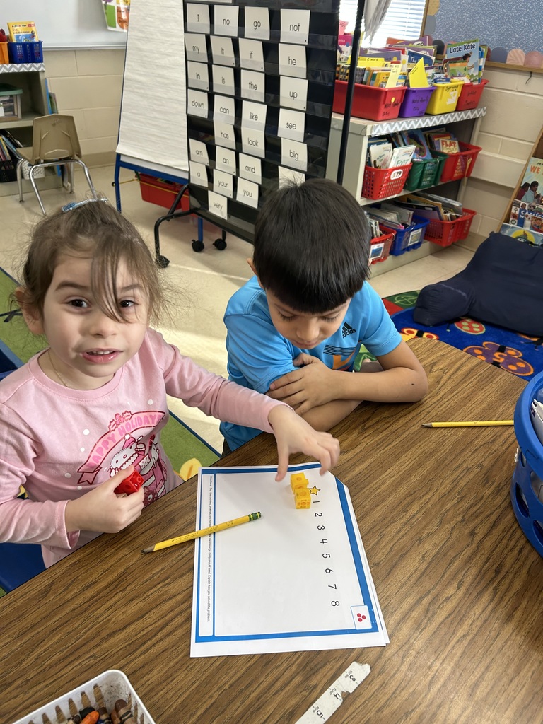 two students using cubes to model addition and subtraction