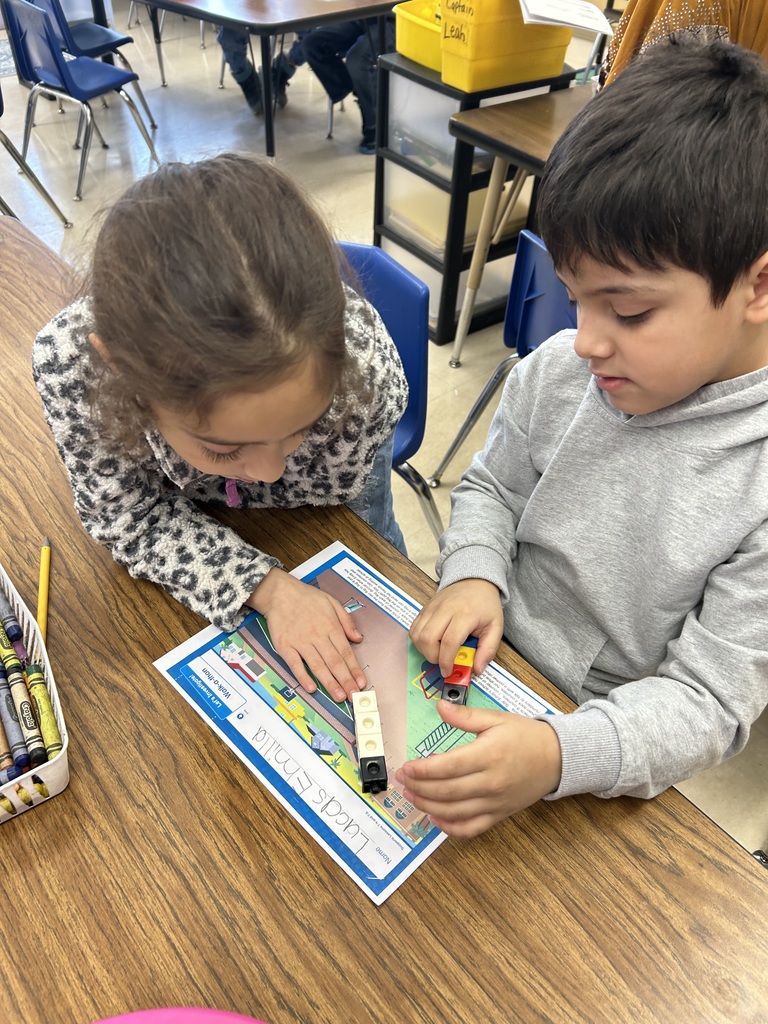 two students using cubes to model addition and subtraction