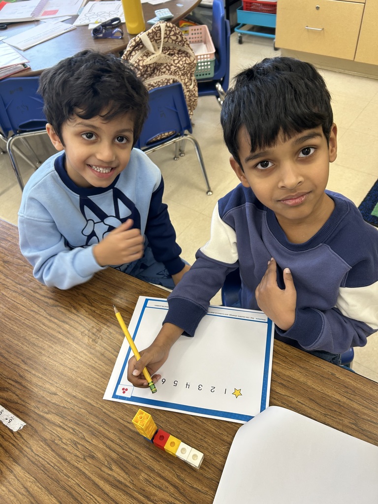 two students using cubes to model addition and subtraction