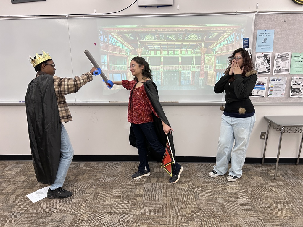 Three high school students are in costume, giving their own creative interpretation of the scene from Othello where Ludovico checks  Othello's outburst of anger toward his wife Desdemona.