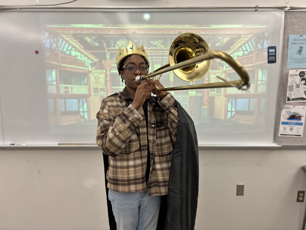 A high school student costumed as Othello plays a fanfare introducing her own character's entrance.