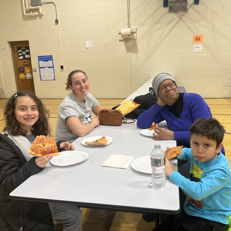 kids and adults eating pizza