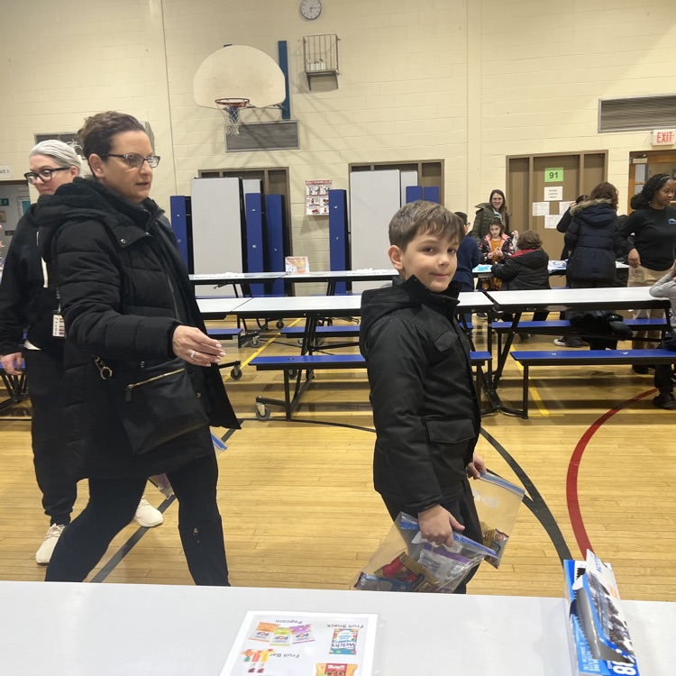 students and parents holding their completed donation bags