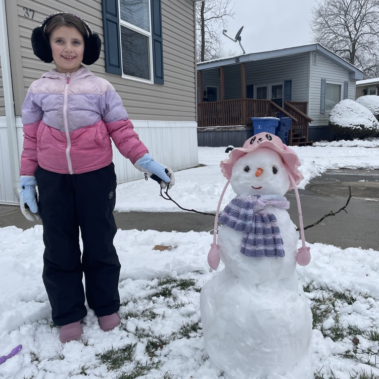 kid standing with little snowman