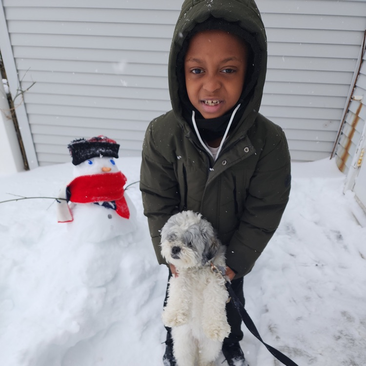 kid standing with little snowman
