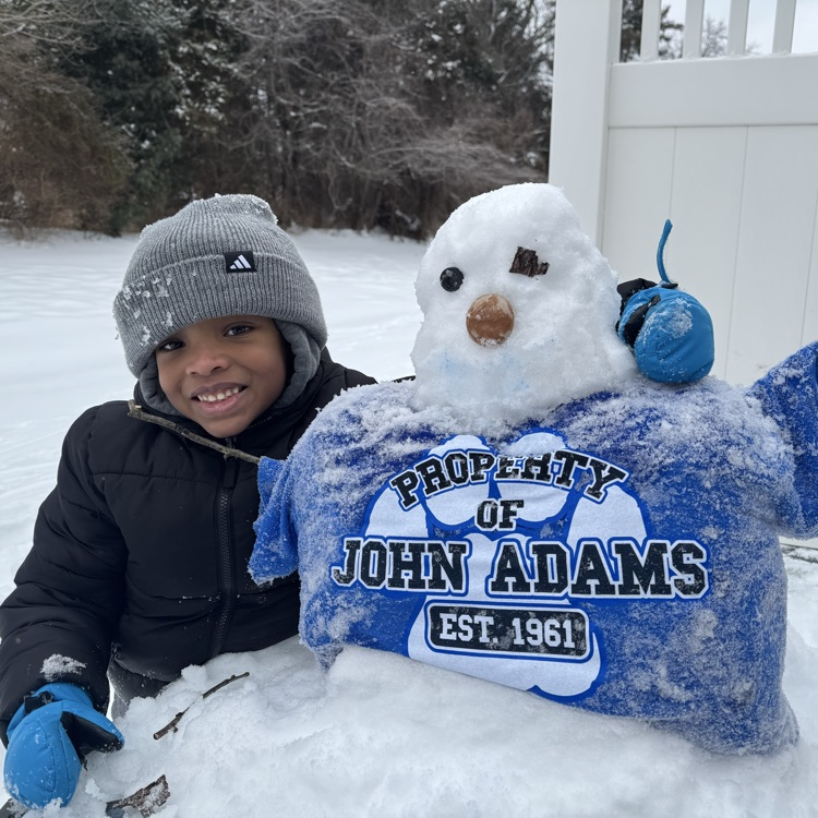 kid standing with little snowman