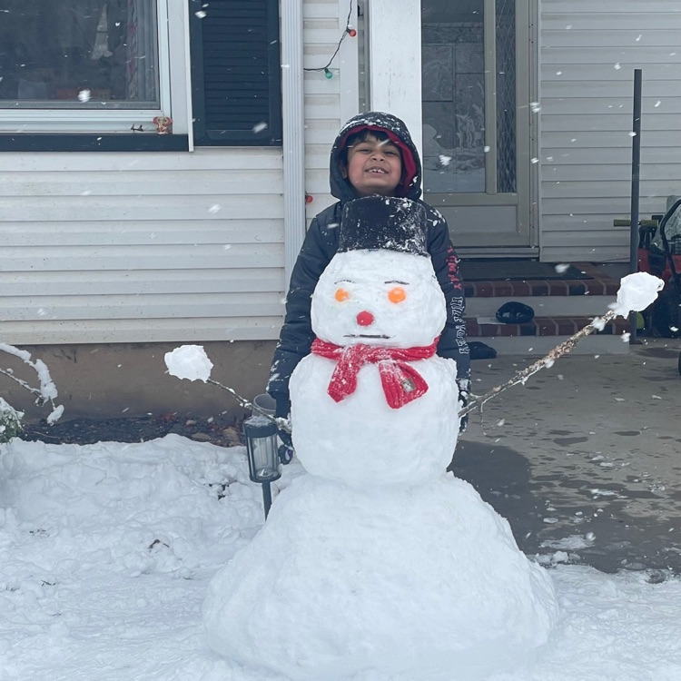 kid standing with little snowman