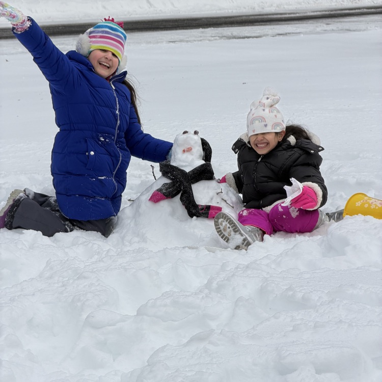 kid standing with little snowman