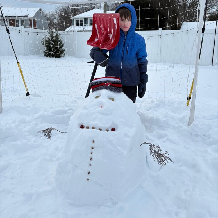 kid standing with little snowman