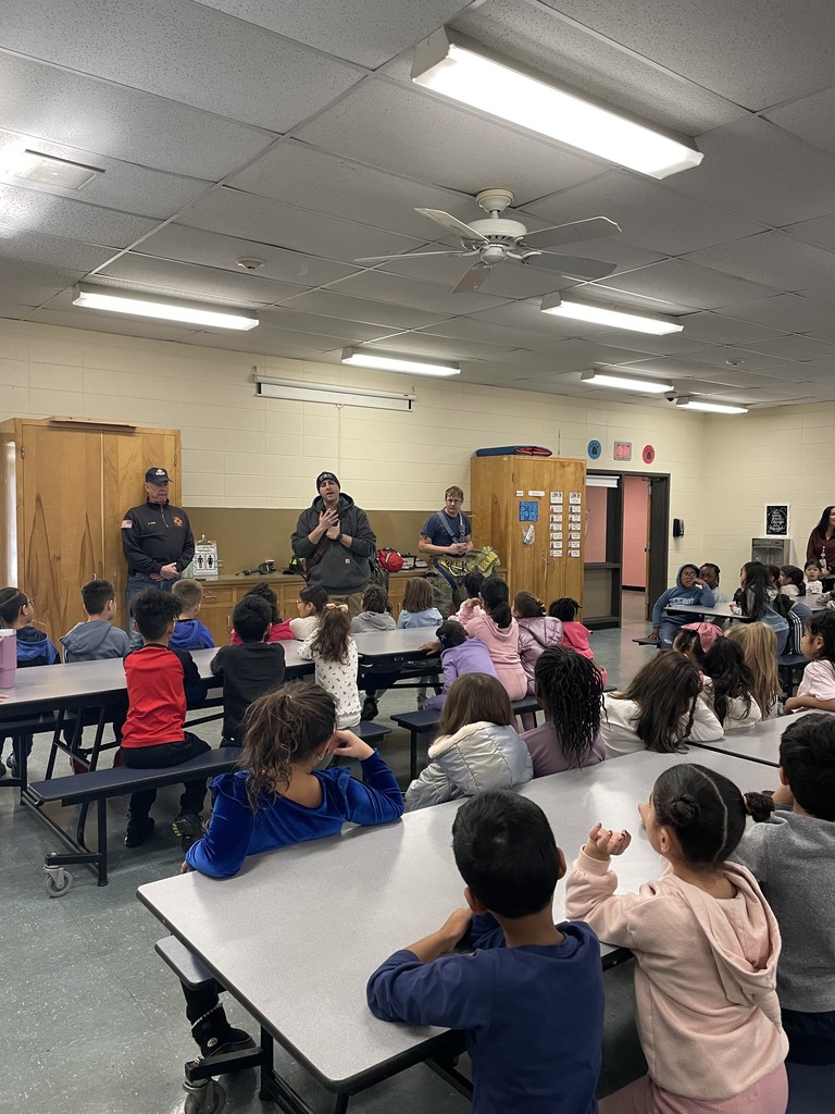 Students listening to firefighters presenting to them