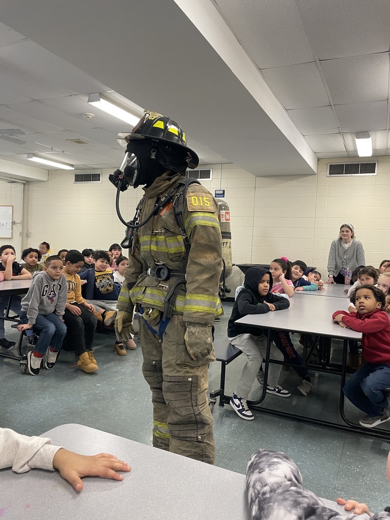 Students listening to firefighters presenting to them