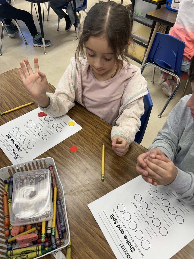 a student using 5 red and yellow counters to break apart the number 5