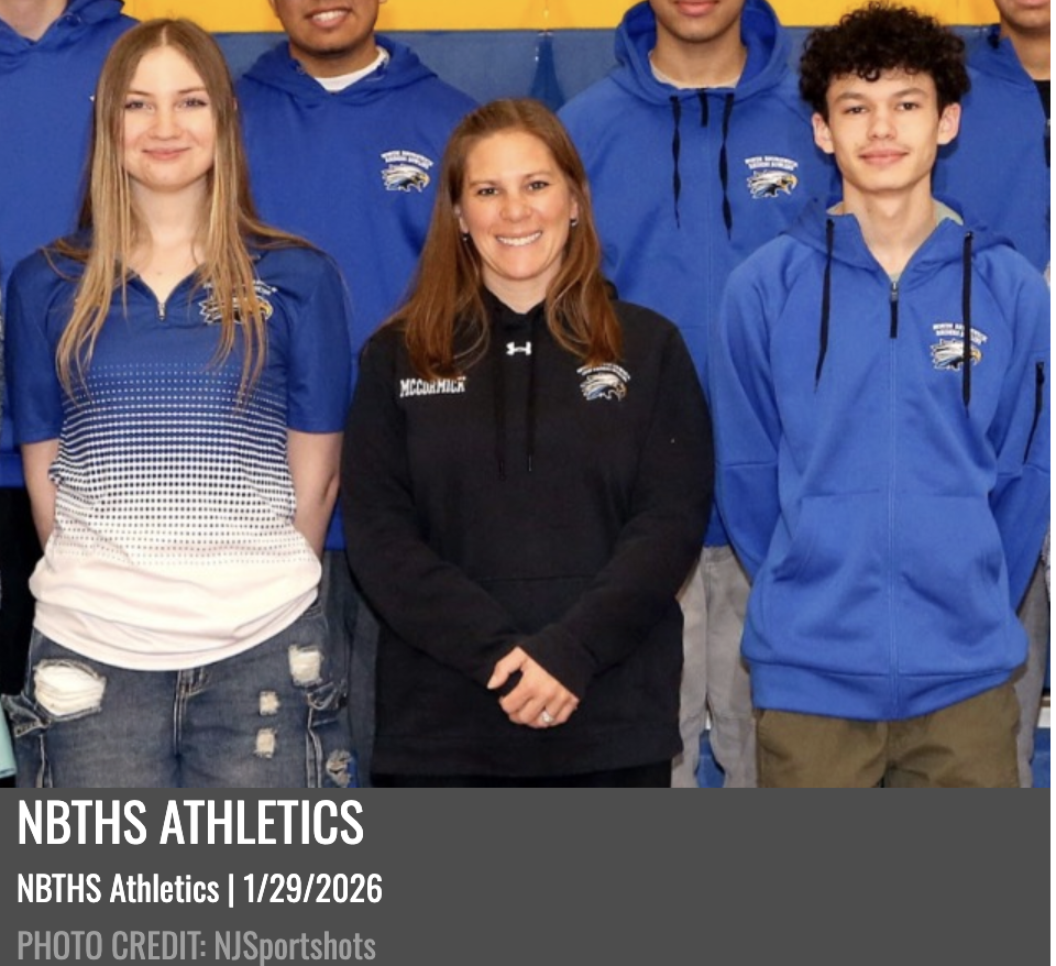Girl and boy bowlers standing with their coach.
