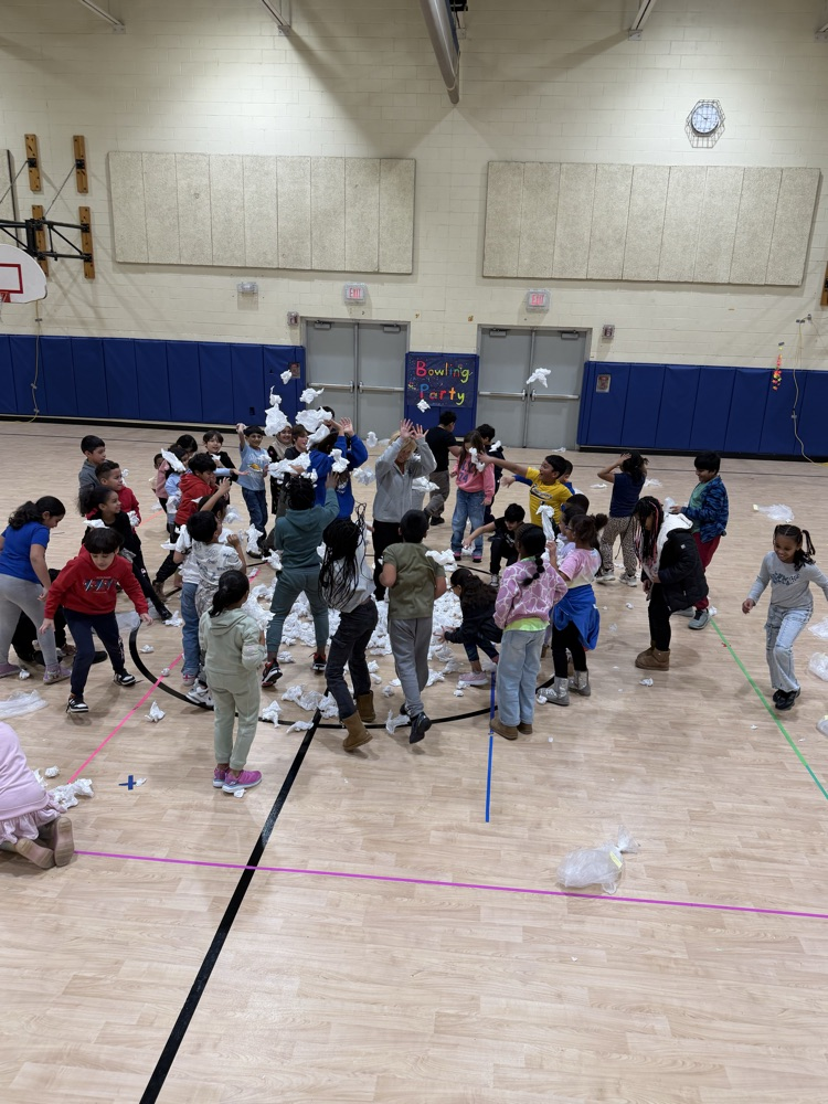 students with pretend snowballs in a gymnasium