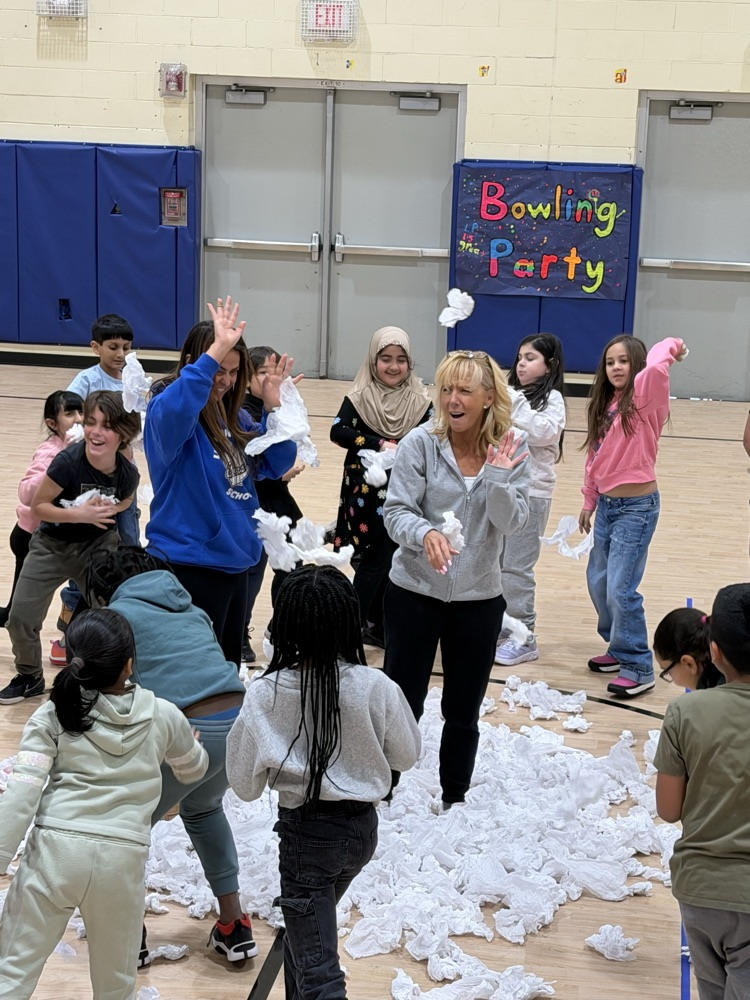 students with pretend snowballs in a gymnasium