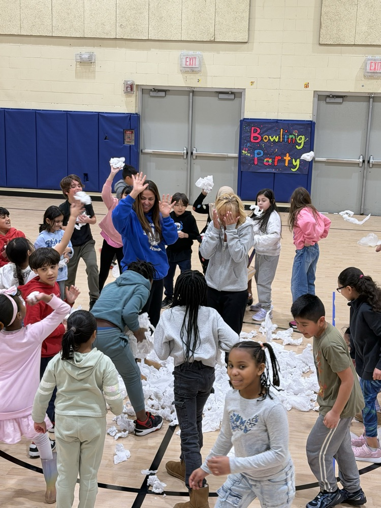 students with pretend snowballs in a gymnasium