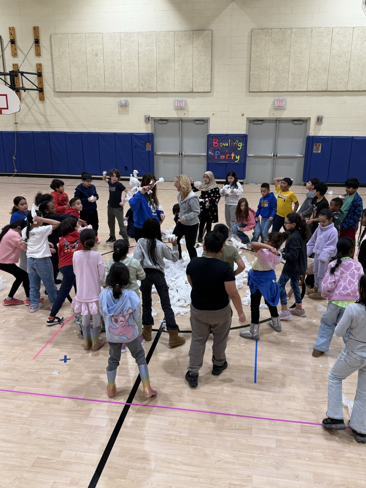 students with pretend snowballs in a gymnasium