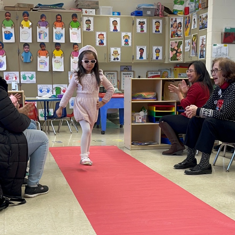 Student walking down a pretend red carpet runway