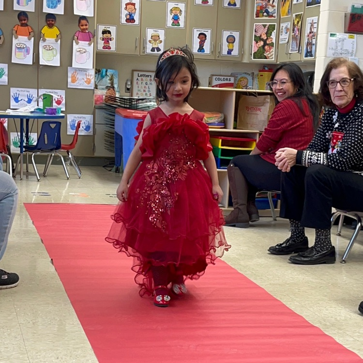 Student walking down a pretend red carpet runway