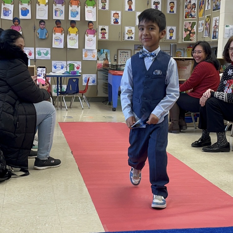 Student walking down a pretend red carpet runway
