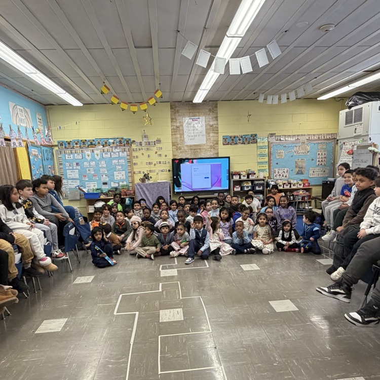 Group of students sitting on the floor and on chairs