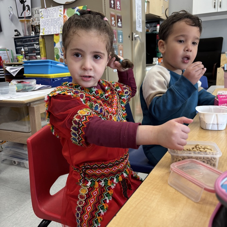 student eating snack at table