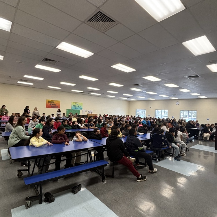 people sitting at cafeteria tables