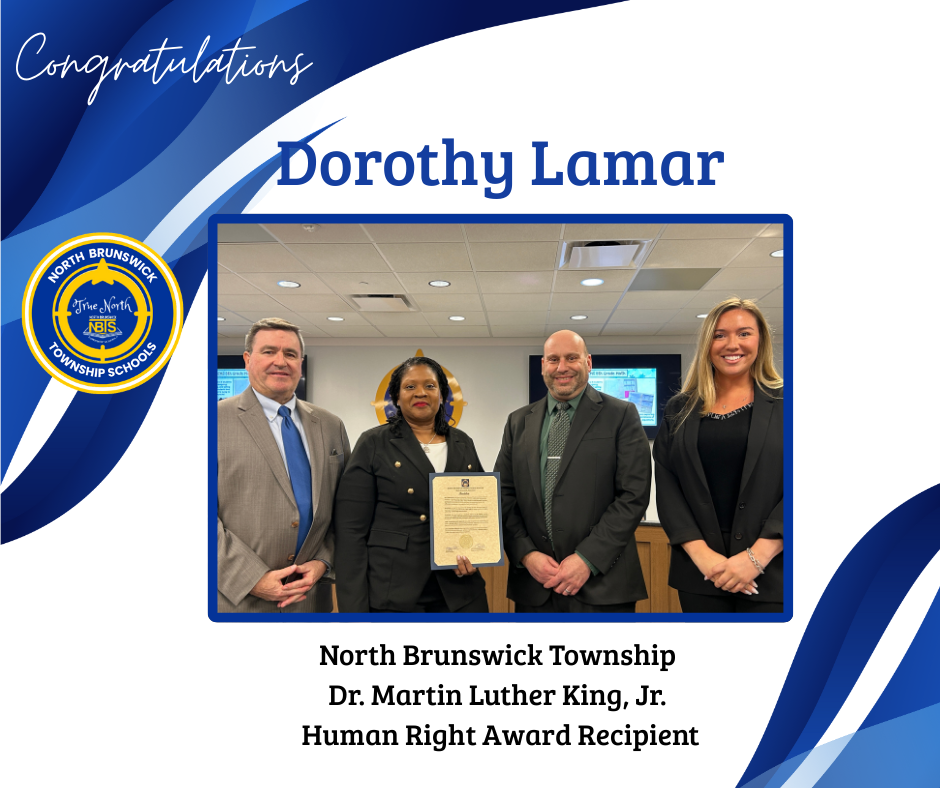 Group of four staff members with one person holding a certificate of achievement for Dr. Martin Luther King, Jr. Human Right Award Recipient