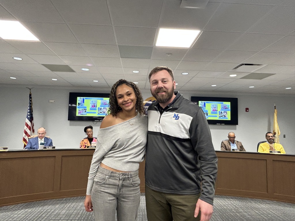 Student and teacher standing together