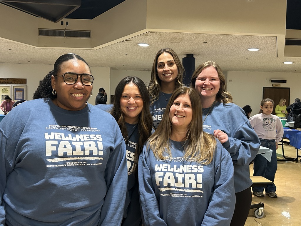 Group of five women wearing Wellness Fair sweatshirts
